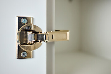 Hinge cabinet of kitchen cupboard door golden metal furniture isolated on white background,...