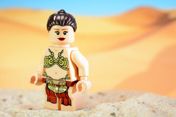 Fototapeta premium Lego Star Wars figure Princess Leia Organa in a metal bikini on the desert planet Tatooine