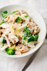 Whole grain penne pasta with chicken and green vegetables.