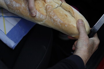 Person slicing bread