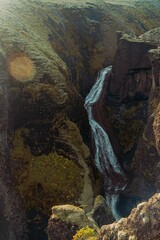Vertical shot of a waterfall in the mountains