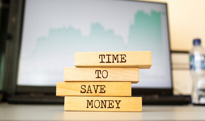 Wooden blocks with words 'TIME TO SAVE MONEY'.