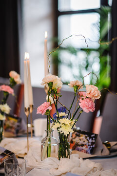 Luxury elegant table setting dinner in a restaurant. Selective focus. Preparation, decorating of banquet table for a birthday party. Wedding reception. Decor of flowers, greenery and candles. Closeup.