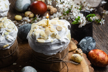 Easter cake with meringue and almond petals on a wooden background