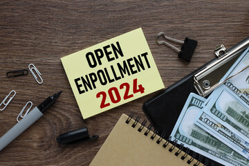 open enrollment 2024. text on a sticker next to money and banknotes