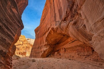 Fototapeta na wymiar Narrow crevasse filled with bright red-colored rocks, Utah Canyons