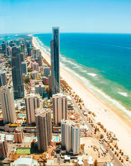 Naklejka premium Aerial view of skyscrapers standing beside the Surfers Paradise beach in Gold Coast in sunny days