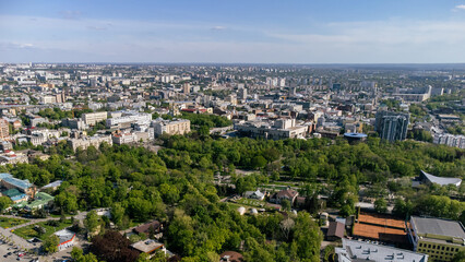 Fototapeta na wymiar Aerial spring sunny view on green Shevchenko city park with blue sky in Kharkiv, Ukraine