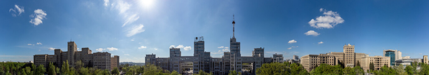 Fototapeta na wymiar Aerial wide panorama on Derzhprom and Karazin National University buildings on Freedom Square with blue sunny sky in Kharkiv, Ukraine