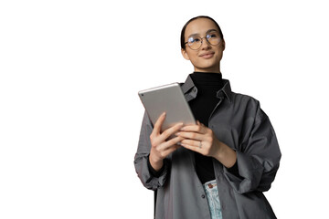 A young woman with glasses in a gray shirt uses a tablet to communicate on a social network, transparent background.