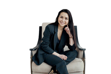 A business woman in formal clothes, sitting in an armchair, smiling and looking at the camera,...