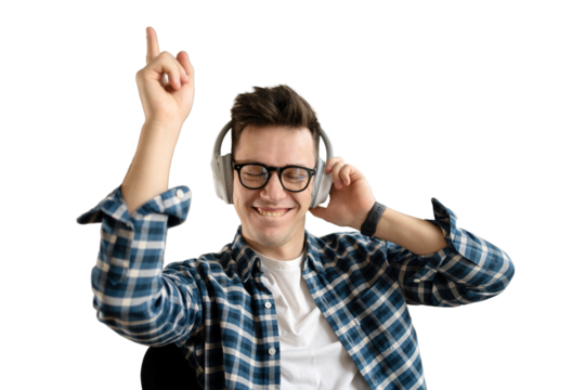 Listening to music with headphones and dancing, a young guy intern with glasses student portrait looks at the camera smiling, transparent background.