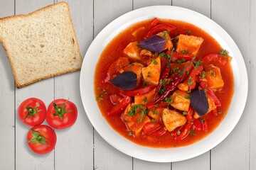 Bowl of hot tasty soup dish on the desk