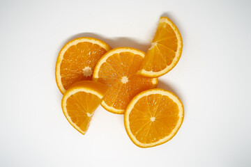 Five slices of ​​orange on white isolated studio background top view