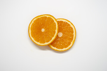 Two slices of ​​orange on white isolated studio background top view