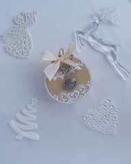 Necklace on white cloth with Christmas decorations.