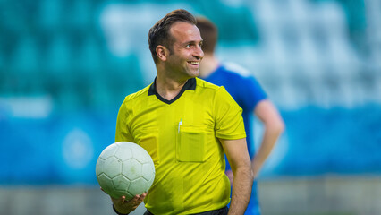 International Soccer Football Championship Match: Portrait of Professional Referee Holding a Ball....