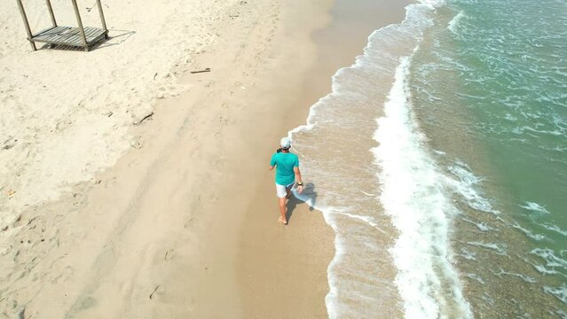 Man walking alone on a paradisiacal beach
