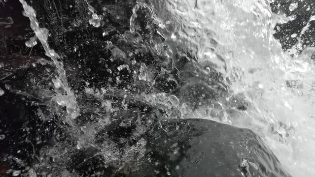 Waterfall flowing water in closeup slomotion