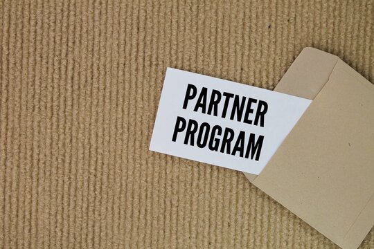 envelope and white paper with the word program partner. the concept of a friend program or invite a friend