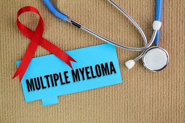 stethoscope, red ribbon and colored paper with the word Multiple Myeloma. medical and patient...