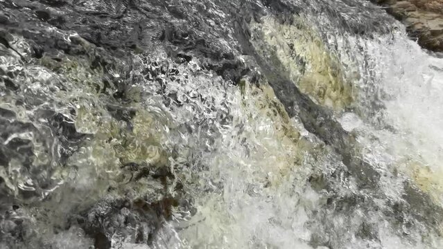 Waterfall flowing water in closeup slomotion