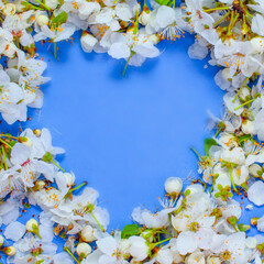 Beautiful white floral around a blue heart. Copy space for text or design.