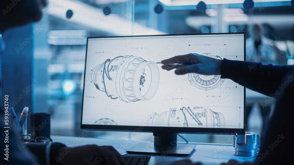 Fototapete Close Up of a Desktop Computer Monitor Screen with 3D CAD Software with Prototype Jet Engine Project. Two Specialists Discussing Work, Their Hands Visible In Front of the Screen.