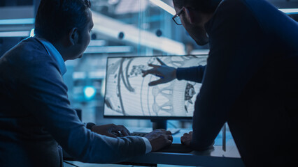 Two Turbine Engine Developers Working on Programming a Prototype Jet Engine on Desktop Computer....