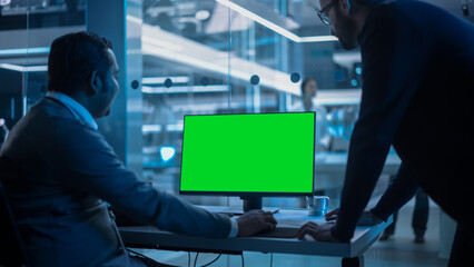 Two Developers Working on Computer with Green Screen Mock Up Display. Scientific Lab, Engineering...