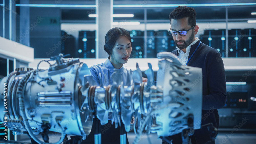 Poster two multiethnic employees work in modern innovative research facility with a futuristic jet engine. 
