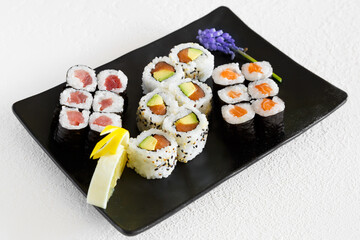 Assortiment de california rolls et maki sur un fond blanc. Cuisine japonaise