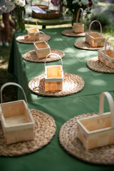 Image of a table with many wooden linen baskets for floral arrangement, sunlight falls. Floristic masterclasses.