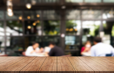 Empty wooden table top with lights bokeh on blur restaurant background.