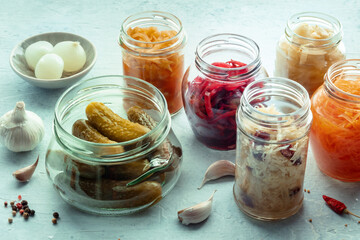 Fototapeta na wymiar Fermented food. Homemade vegetable preserves. Sauerkraut, pickles, kimchi etc in glass jars. Canning for winter. Healthy probiotic diet