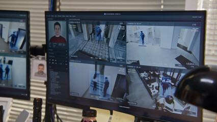 Close up shot of computers with screen showing footage of surveillance cameras in coworking office with modern facial recognition system. CCTV cameras. High tech security. Concept of social safety.