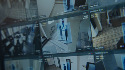 Close up shot of computer or digital tablet screen showing footage of surveillance cameras in...