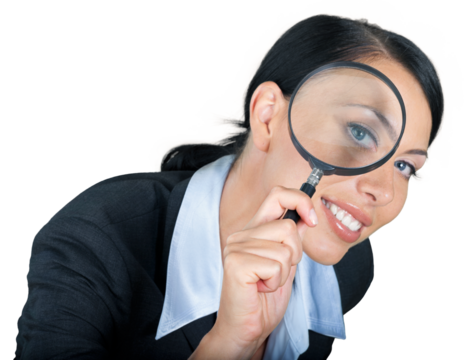 Businesswoman looking through a magnifying glass