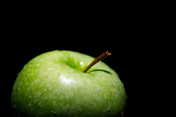 Fresh green apples on black background