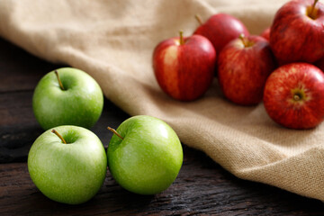 Fresh red and green apples on sack background