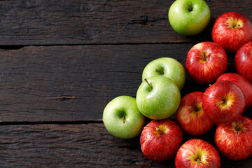 fresh red and green apples on the wooden floor