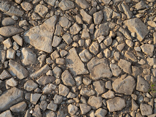 Fond de cailloux qui sont posés au sol. Différentes tailles de cailloux éparpillés sur le sol.