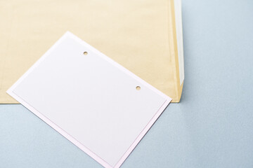 A craft envelope with with a blank sheet, isolated white