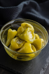 Peppers stuffed with cream cheese in bowl.