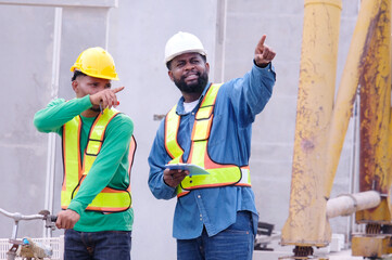 Engineers and workers walking at a construction site.