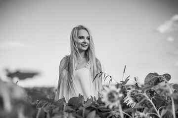 Grayscale shot of an attractive Caucasian female in the field