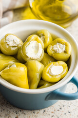 Peppers stuffed with cream cheese in pot.
