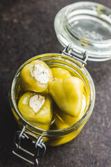 Peppers stuffed with cream cheese in jar.