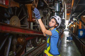 Obraz na płótnie Canvas Female engineer checking equipment in factory for repair