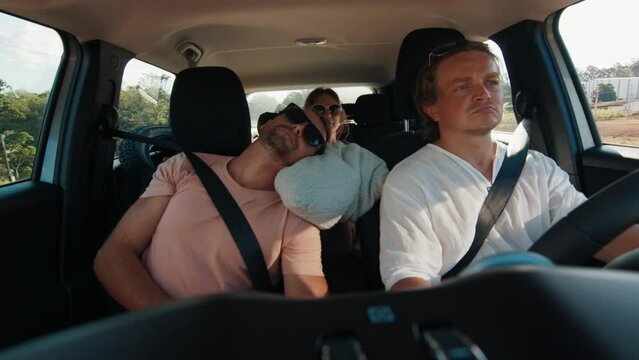 Hyperlapse in the car. Group of friends travel in the car. Interior view of the car with passengers trying to sleep and male driver